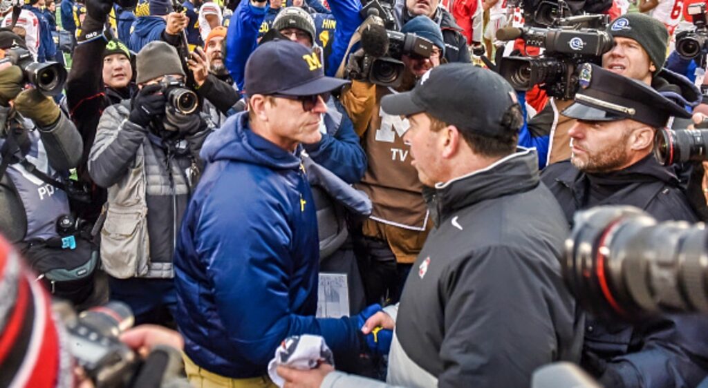 Jim Harbaugh shakes Ryan Day's hand after a game.