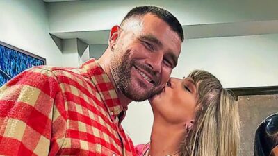 Travis Kelce being kissed by taylor swift
