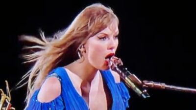 Taylor Swift in blue dress singing
