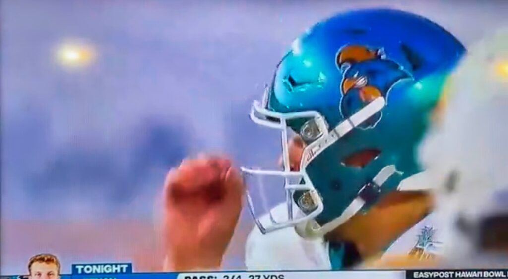 Costal Carolina quarterback doing a hand signal.