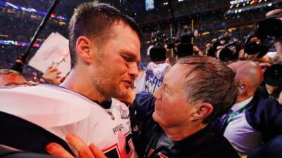 Bill Belichick and Tom Brady embracing each other.