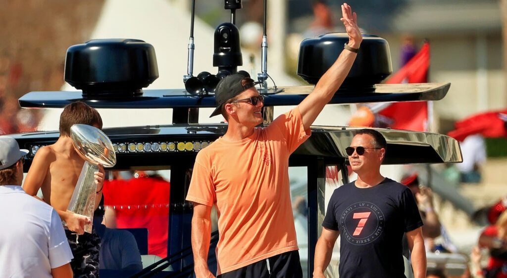 Tom Brady waves from a boat during the Bucs' Super Bowl parade.