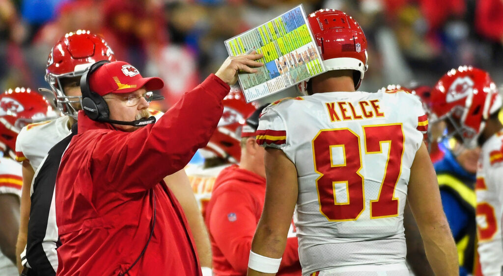 Andy Reid touching Travis Kelce's helmet with his play sheet