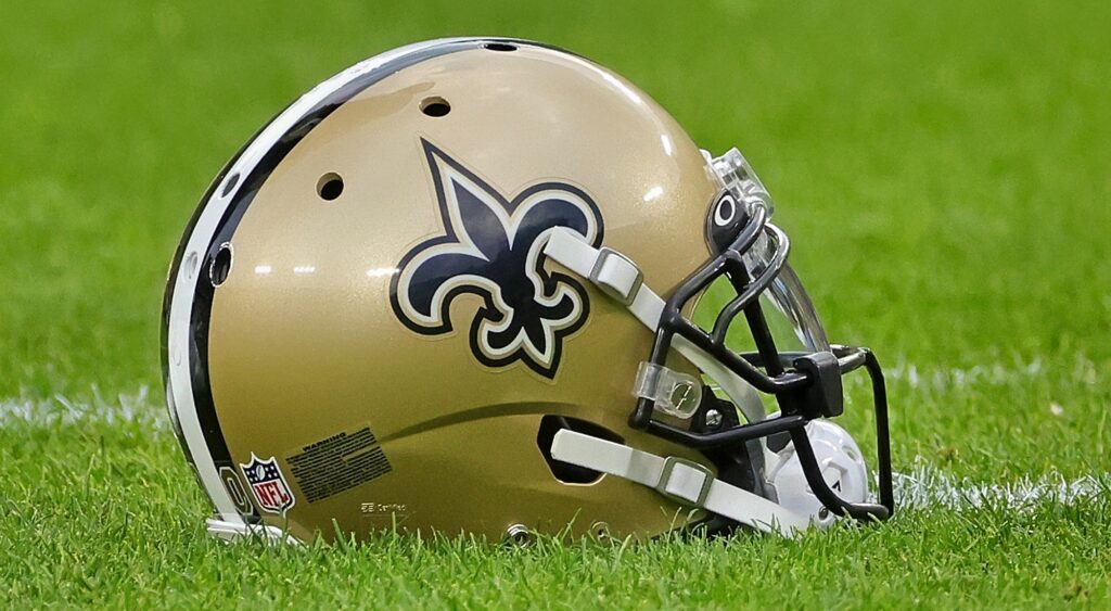 New Orleans Saints helmet shown on field at Lambeau Field.