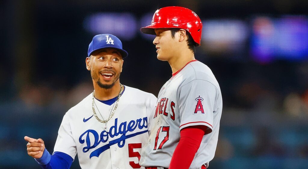 Mookie Betts (left) speaking to Shohei Ohtani (right) during game.