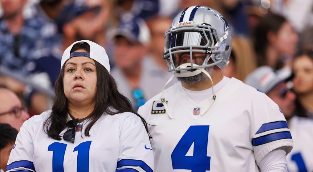 Dallas Cowboys fans looking on during game.