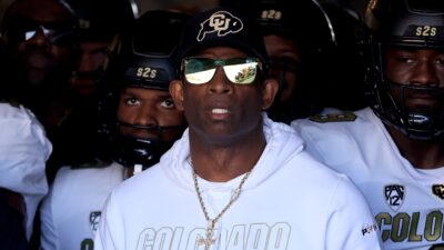 Deion Sanders and players in tunnel