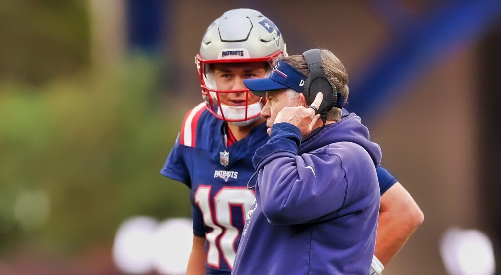 Bill Belichick of New England Patriots talking to quarterback Mac Jones.