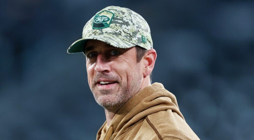 Aaron Rodgers wearing Jets cap