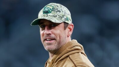 Aaron Rodgers wearing Jets cap