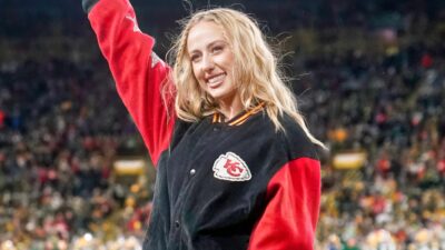 Brittany Mahomes posing in Chiefs jacket