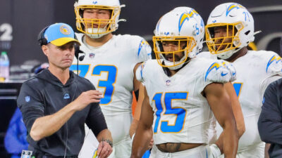 Brandon Staley standing in front of Chargers players