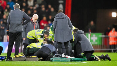 Medical personnel tending to Tom Lockyer after defender collapses during EPL game