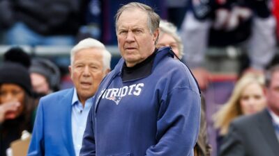 Bill Belichick in Patriots hoodie with Robert Kraft in blue suit
