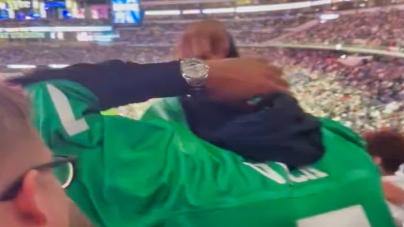 Philadelphia Eagles fan taking ersey off during game.