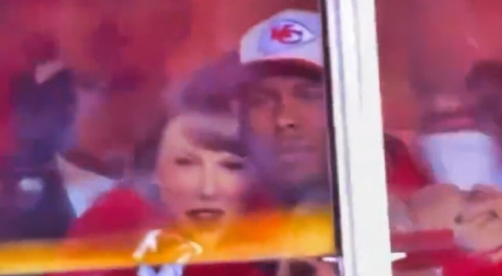 Taylor Swift holding onto man at Chiefs game