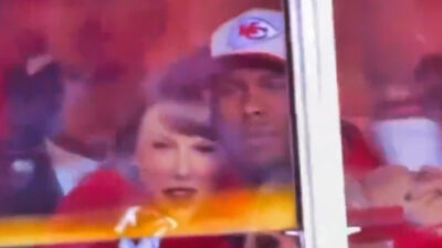 Taylor Swift holding onto man at Chiefs game