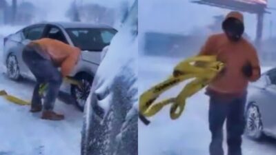 Alec Anderson helping stranded driver in snow