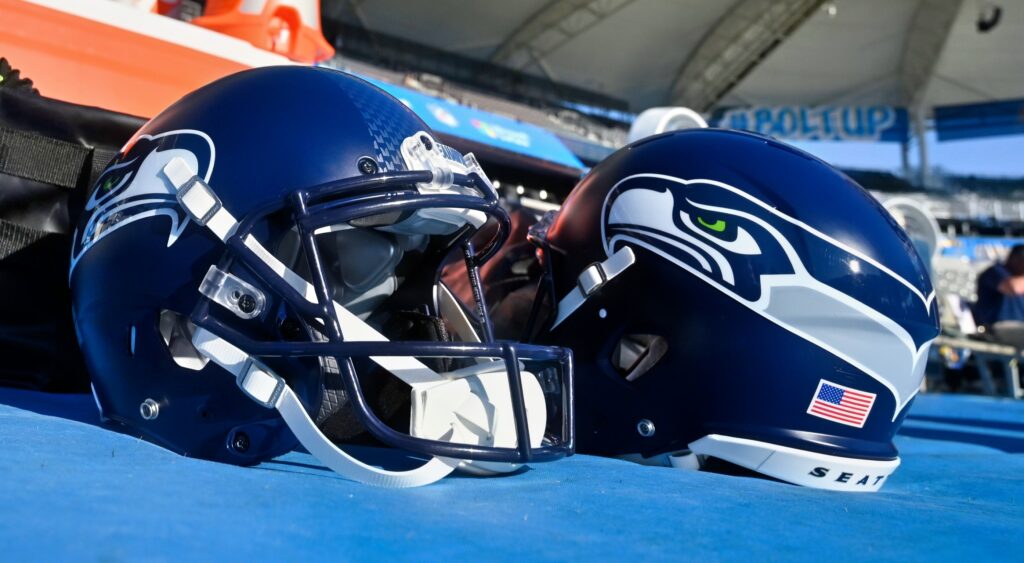 Seattle Seahawks helmets shown on sidelines.