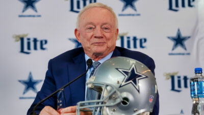 Jerry Jones with Cowboys helmet in front of him
