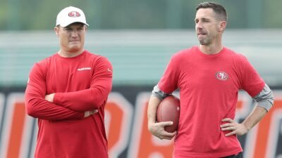 Kyle Shanahan and John Lynch standing side by side