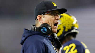 Jim Harbaugh on sidelines with a shocked face