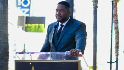 Michael Strahan on behind a podium