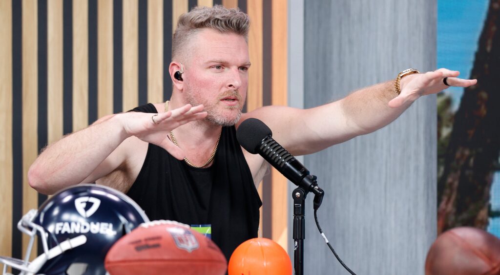 Pat McAfee with his hands up on his podcast show