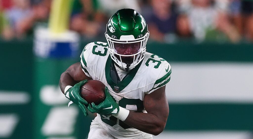 New York Jets running back Dalvin Cook carrying football.