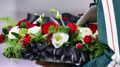 Floral wreath being held
