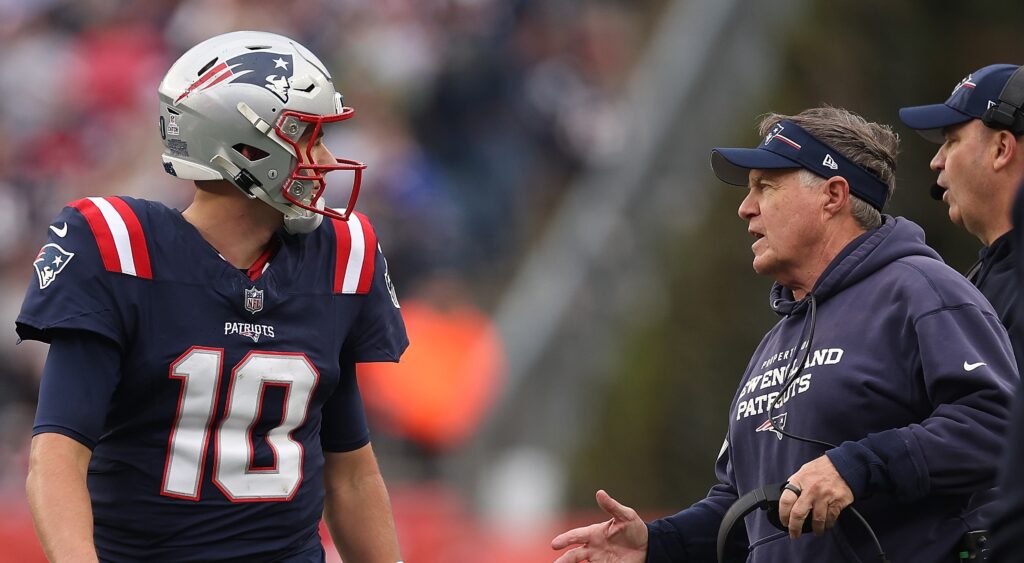 Mac Jones (left) and Bill Belichick (right) talking during Patriots game.