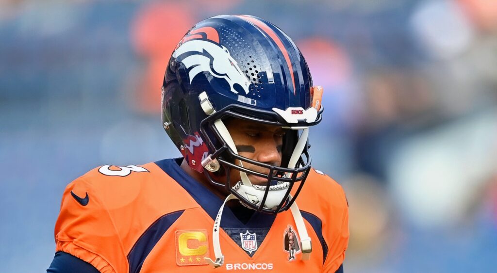 Denver Broncos quarterback Russell Wilson looking on.