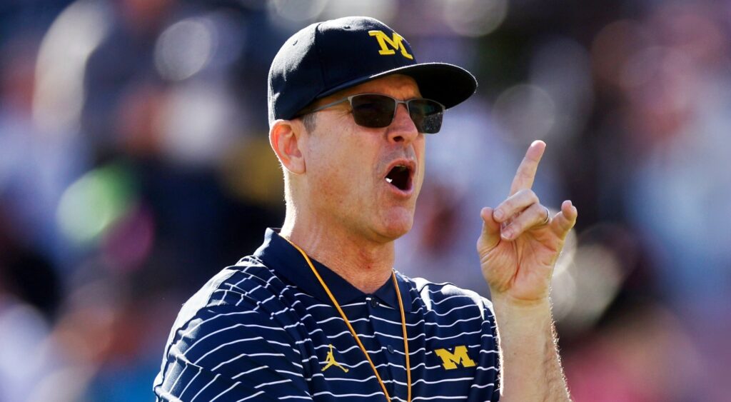 Jim Harbaugh of Michigan Wolverines looking on.