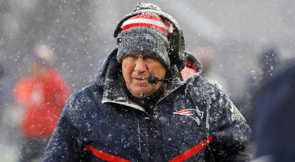 Bill Belichick in winter jacket while snowing