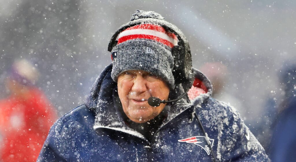 New England Patriots head coach Bill Belichick looking on during game.