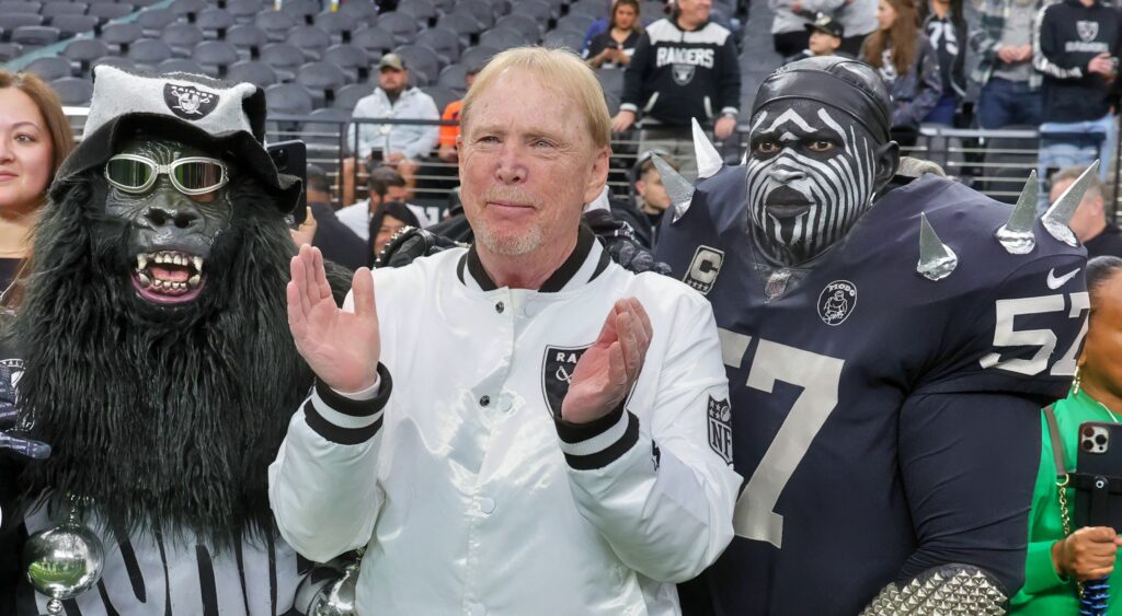 Las Vegas Raiders owner Mark Davis posing with fans for photo.
