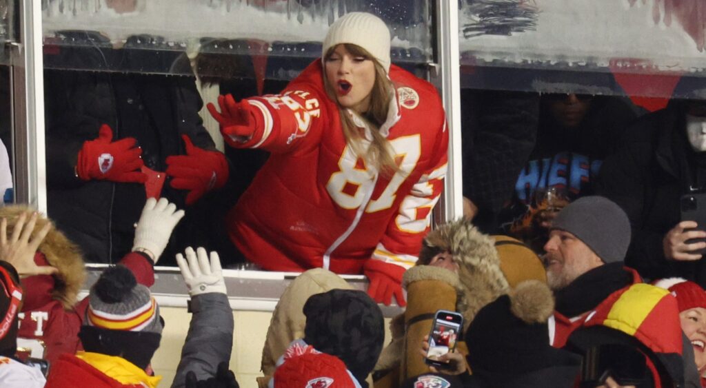 Taylor Swift greeting fans from suite