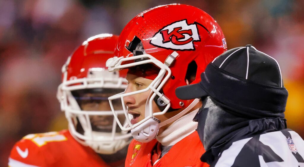 Patrick Mahomes looks on with a crack in his helmet.