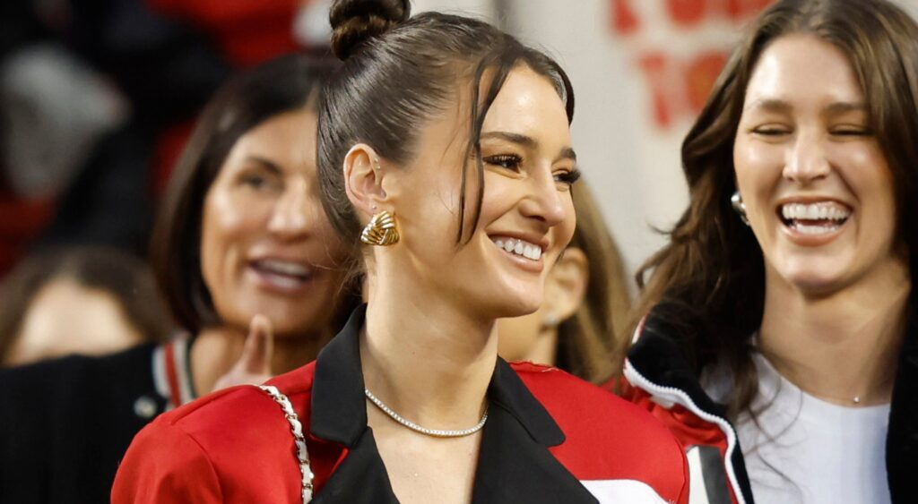Kristin Juszczyk smiling while on the sidelines