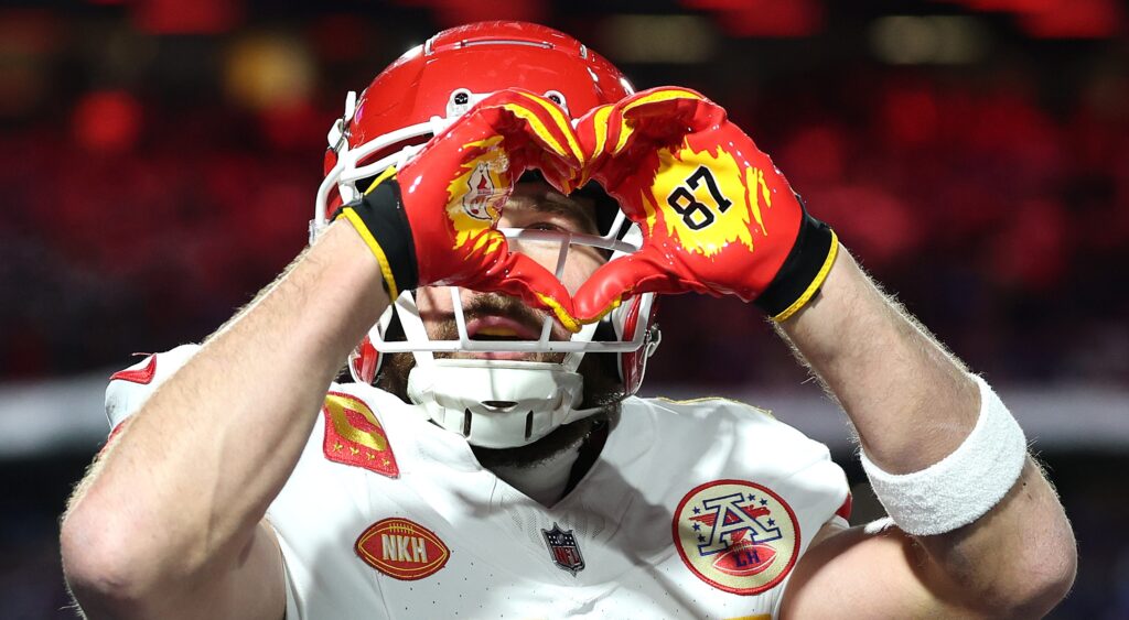 Travis Kelce holding up heart sign