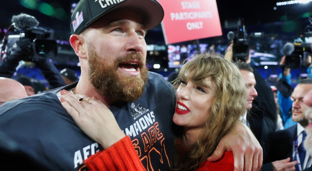 Travis Kelce and Taylor Swift holding each other