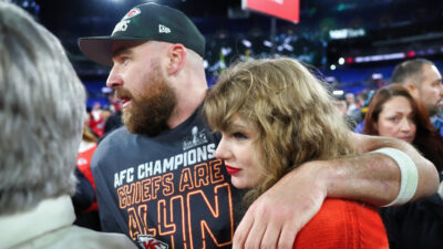 Travis Kelce with an arm around Taylor Swift