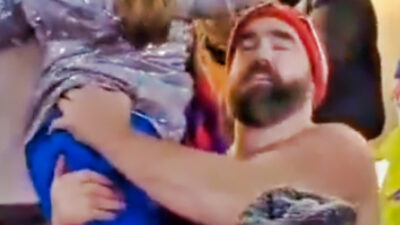 Jason Kelce holding up a young girl