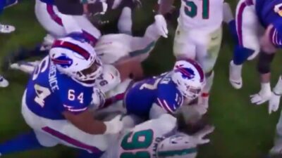 Josh Allen on ground surrounded by Dolphins players