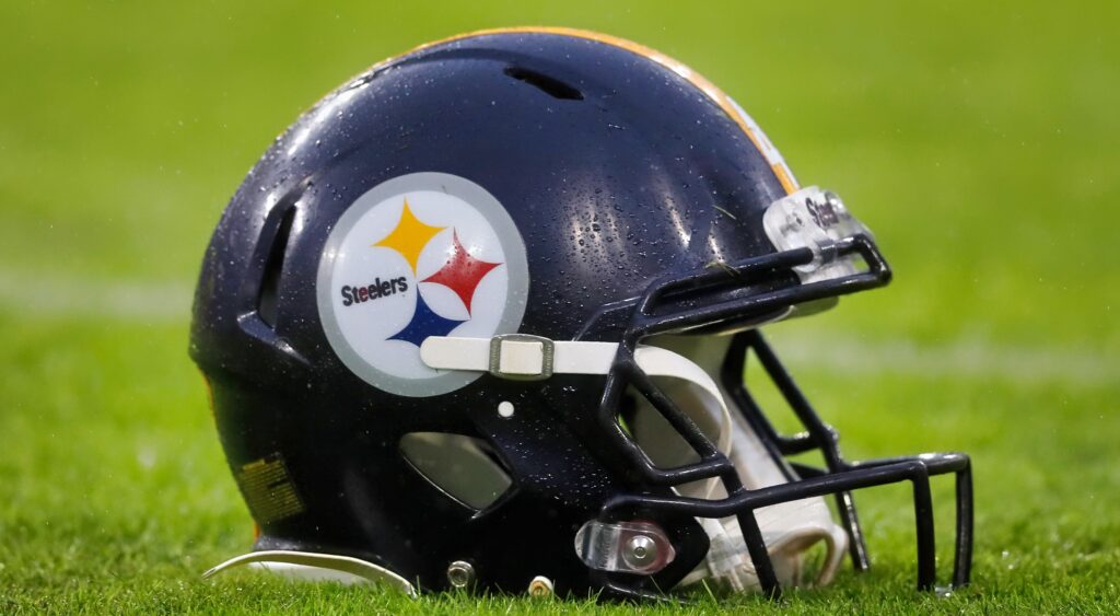Pittsburgh Steelers helmet shown on turf.