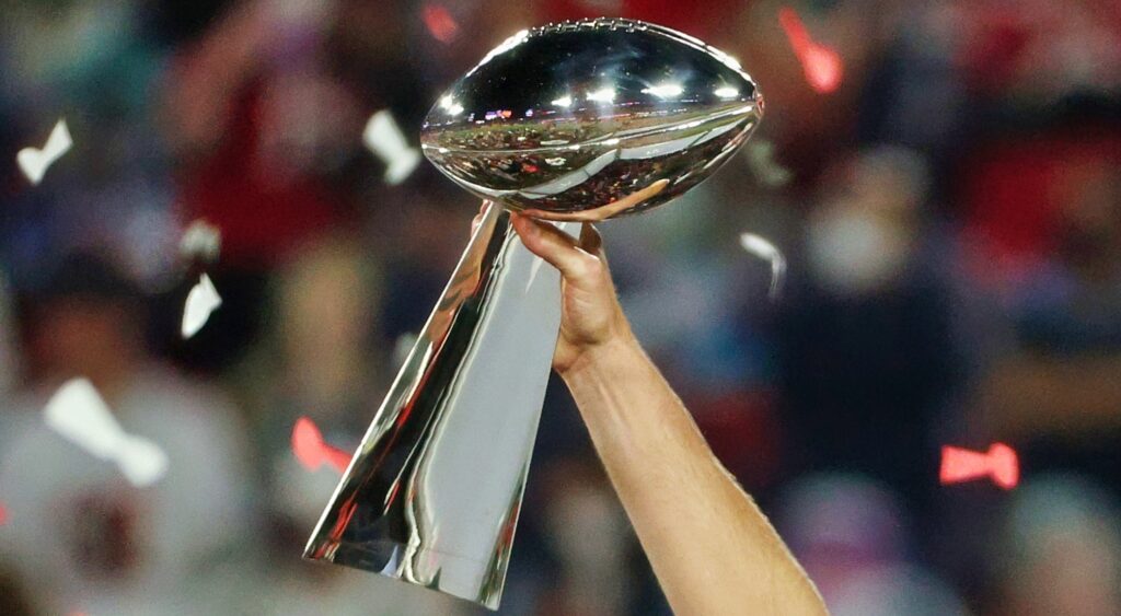 Player holds up the Vince Lombardi trophy.
