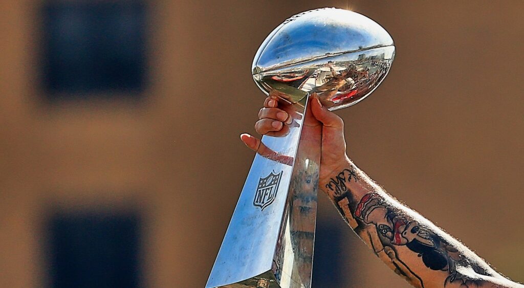 Player lifts the Lombardi Trophy.