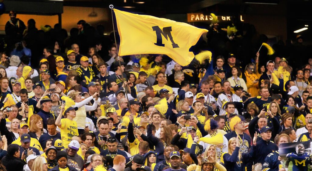 Michigan fans holding flag