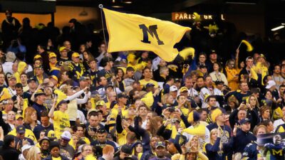 Michigan fans holding flag