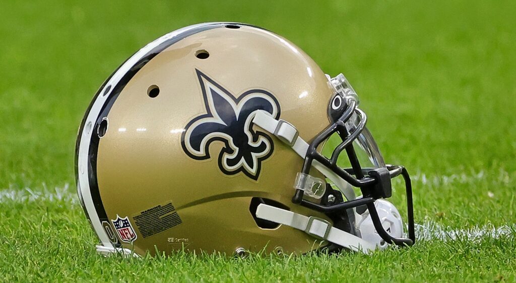 New Orleans Saints helmet shown on Lambeau Field.